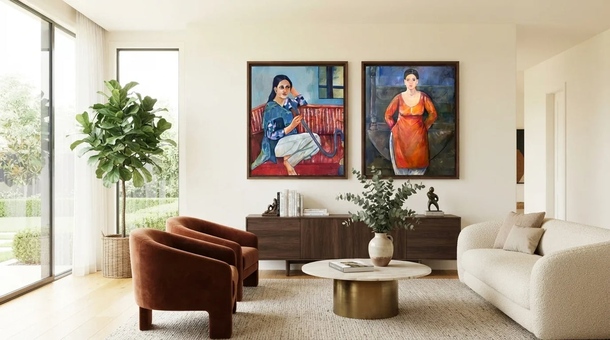 A white couch sits below two vibrant figurative art paintings in a stylish living room.