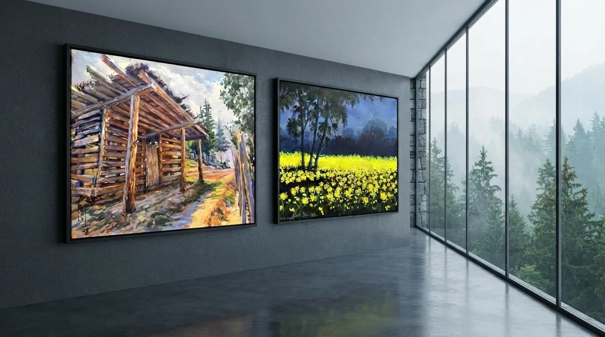 Two elegant landscape wall art frames featuring a cabin and mountain, placed in front of a window for a scenic effect.