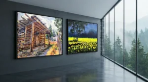Two elegant landscape wall art frames featuring a cabin and mountain, placed in front of a window for a scenic effect.